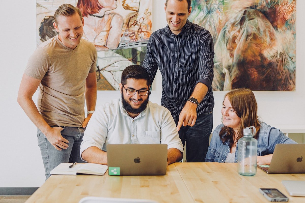 A small business team around a laptop